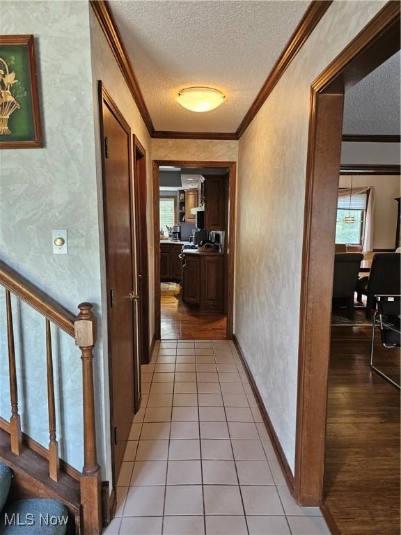 6671 Queens Way N, Royalton, OH 44133 - hallway with a textured ceiling, crown molding, plenty of natural light, a textured wall, and an office area