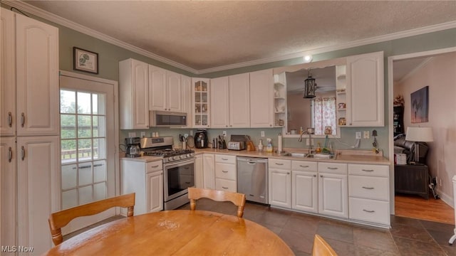 21 E Maple Ave, New Concord, OH 43762 - kitchen with stainless steel appliances, a sink, light countertops, crown molding, and open shelves