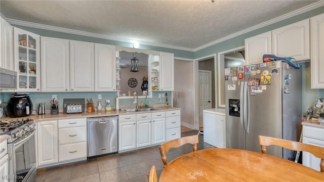 21 E Maple Ave, New Concord, OH 43762 - kitchen featuring appliances with stainless steel finishes, a sink, a textured ceiling, white cabinetry, and glass insert cabinets