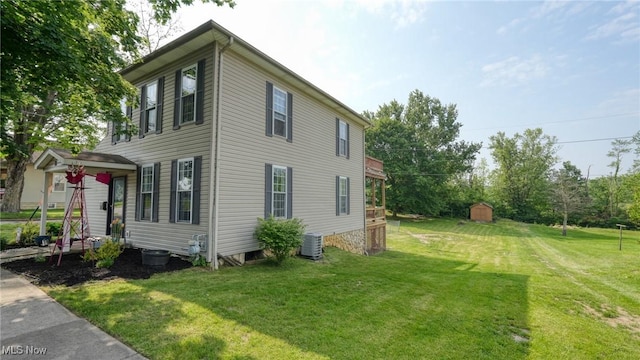 21 E Maple Ave, New Concord, OH 43762 - view of property exterior featuring cooling unit and a yard