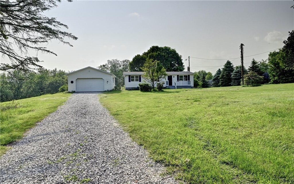 4932 New Cumberland Rd NE, Mineral City, OH 44656 - ranch-style home featuring an outdoor structure, a front yard, and a detached garage