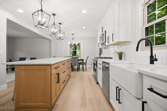 6730 Stone Rd, Medina, OH 44256 - kitchen featuring stainless steel appliances, a chandelier, a sink, light wood finished floors, and recessed lighting