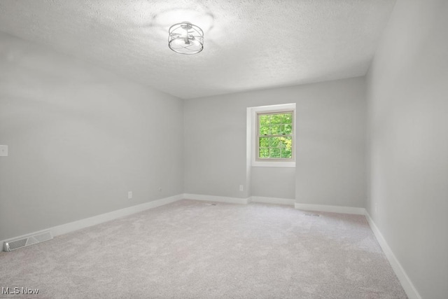 6730 Stone Rd, Medina, OH 44256 - spare room with a textured ceiling, light colored carpet, and baseboards