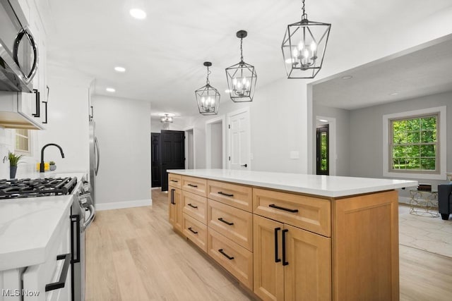 6730 Stone Rd, Medina, OH 44256 - kitchen with gas stove, a chandelier, light countertops, light wood finished floors, and recessed lighting
