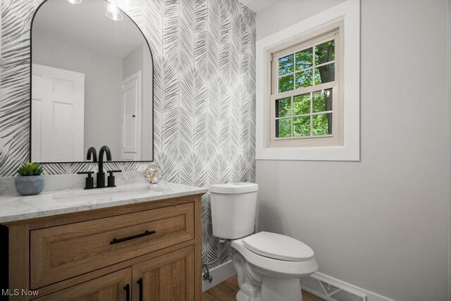 6730 Stone Rd, Medina, OH 44256 - bathroom featuring baseboards, vanity, toilet, and wallpapered walls