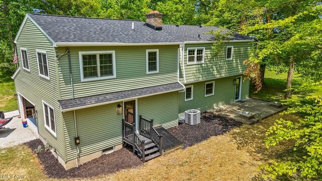 6730 Stone Rd, Medina, OH 44256 - back of property with a chimney, central AC, a patio, a shingled roof, and a garage