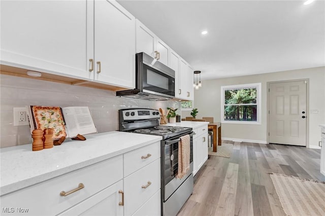 5679 Wilson Mills Rd, Highland Heights, OH 44143 - kitchen with stainless steel appliances, backsplash, white cabinets, light wood-style floors, and recessed lighting