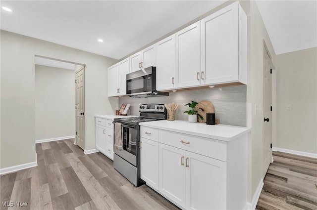 5679 Wilson Mills Rd, Highland Heights, OH 44143 - kitchen featuring appliances with stainless steel finishes, light wood-type flooring, tasteful backsplash, white cabinets, and recessed lighting
