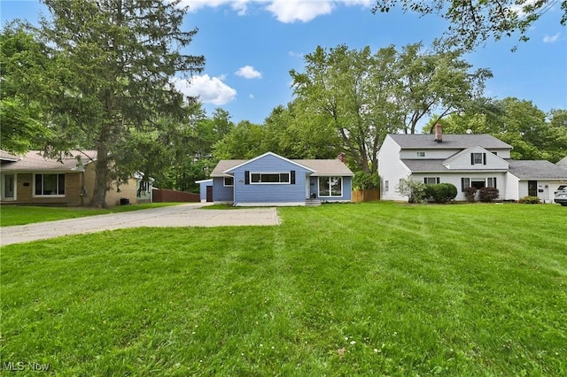 5679 Wilson Mills Rd, Highland Heights, OH 44143 - view of front of property with a front yard, a chimney, and driveway