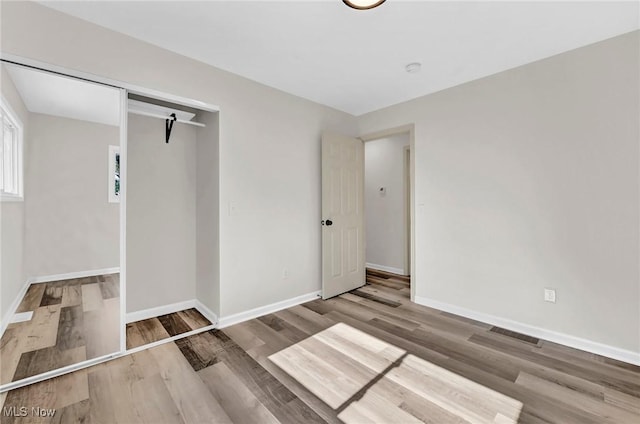 5679 Wilson Mills Rd, Highland Heights, OH 44143 - unfurnished bedroom with wood finished floors and baseboards