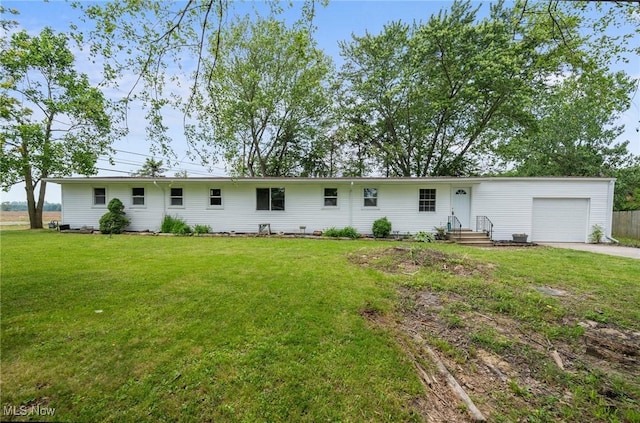 403 Palomino Ct, Lagrange, OH 44050 - rear view of property featuring a garage, concrete driveway, and a yard