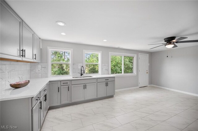403 Palomino Ct, Lagrange, OH 44050 - kitchen with a sink, gray cabinets, light countertops, a ceiling fan, and light marble finish floors