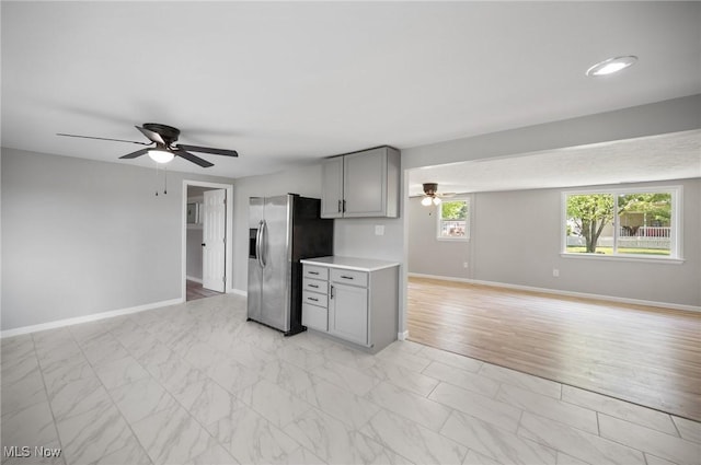 403 Palomino Ct, Lagrange, OH 44050 - kitchen with stainless steel refrigerator with ice dispenser, gray cabinetry, ceiling fan, and open floor plan