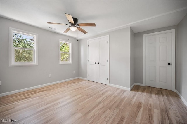 403 Palomino Ct, Lagrange, OH 44050 - unfurnished bedroom with baseboards, light wood-type flooring, a closet, and ceiling fan