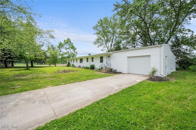 403 Palomino Ct, Lagrange, OH 44050 - ranch-style house featuring an attached garage, concrete driveway, and a front yard