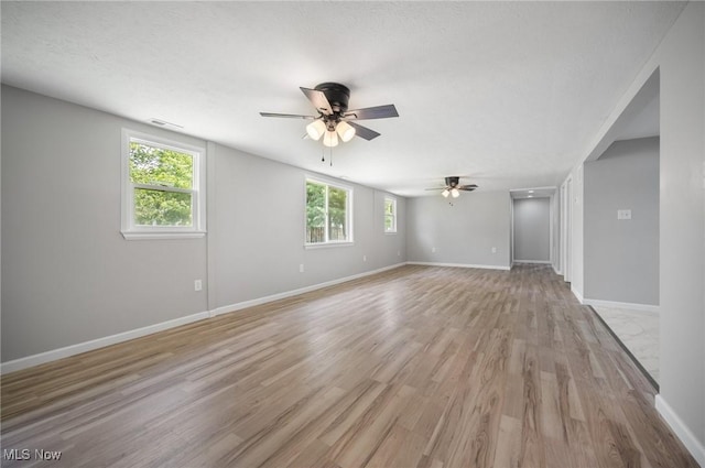403 Palomino Ct, Lagrange, OH 44050 - empty room featuring a ceiling fan, light wood-style floors, and baseboards