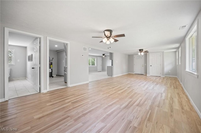 403 Palomino Ct, Lagrange, OH 44050 - unfurnished living room featuring ceiling fan, light wood finished floors, and baseboards