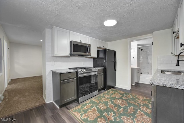 20969 Stanford, Fairview Park, OH 44126 - kitchen with stainless steel appliances, a sink, baseboards, dark wood-type flooring, and a textured ceiling