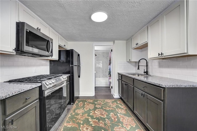 20969 Stanford, Fairview Park, OH 44126 - kitchen featuring stainless steel appliances, a sink, baseboards, dark wood-type flooring, and decorative backsplash