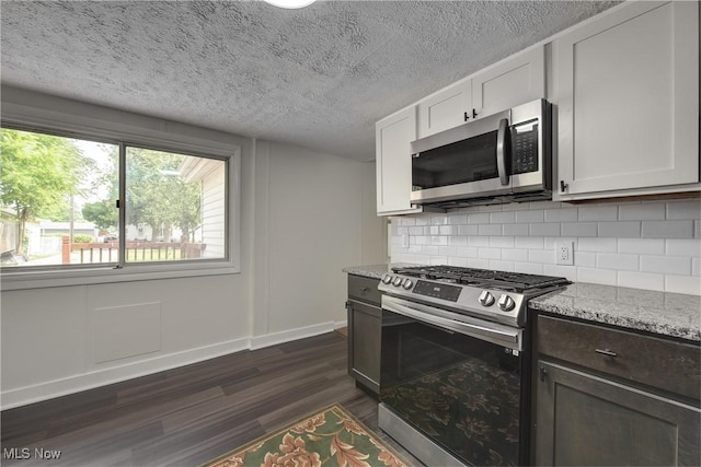 20969 Stanford, Fairview Park, OH 44126 - kitchen featuring appliances with stainless steel finishes, baseboards, dark wood-type flooring, a textured ceiling, and decorative backsplash