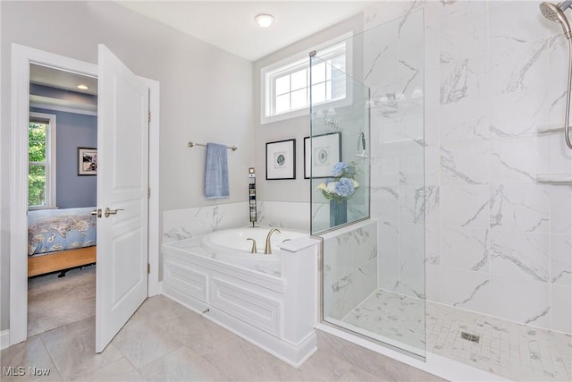 660 Shinnecock Ln, Aurora, OH 44202 - full bathroom featuring a garden tub, a marble finish shower, and plenty of natural light