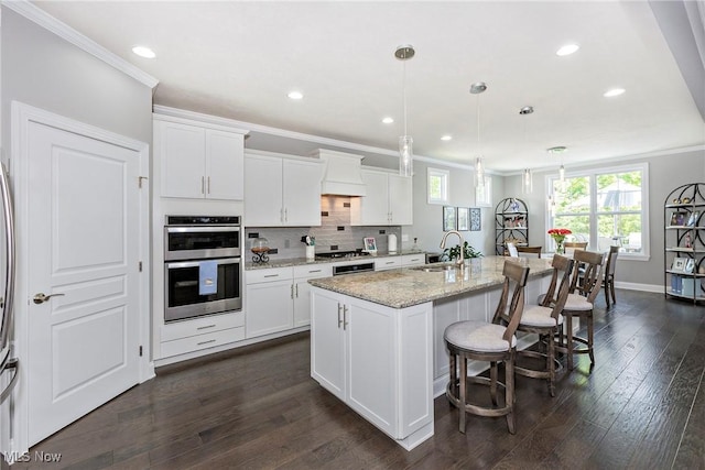 660 Shinnecock Ln, Aurora, OH 44202 - kitchen with appliances with stainless steel finishes, ornamental molding, a sink, a kitchen bar, and white cabinets