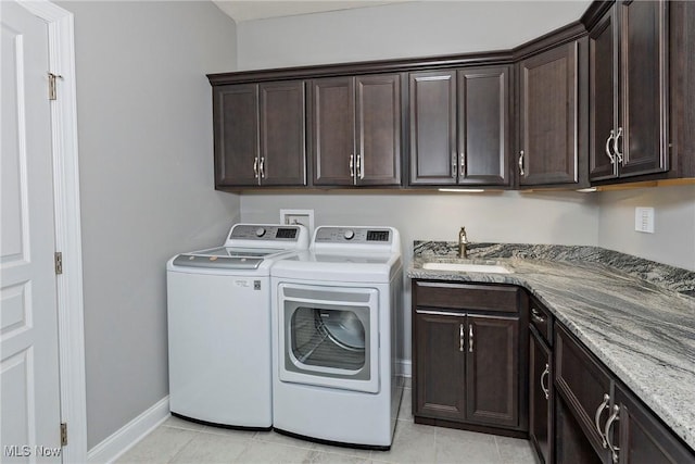 660 Shinnecock Ln, Aurora, OH 44202 - laundry area with cabinet space, washing machine and dryer, light tile patterned floors, and baseboards
