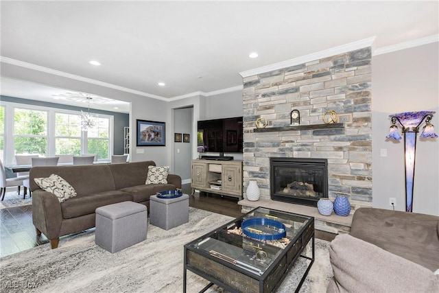 660 Shinnecock Ln, Aurora, OH 44202 - living room featuring wood finished floors, recessed lighting, crown molding, a stone fireplace, and baseboards