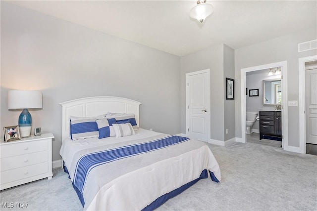 660 Shinnecock Ln, Aurora, OH 44202 - bedroom featuring light colored carpet, connected bathroom, and baseboards
