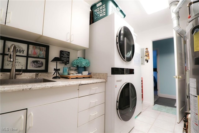 682 2nd St Unit 1, Fairport Harbor, OH 44077 - laundry room featuring cabinet space, stacked washer / drying machine, and light tile patterned floors