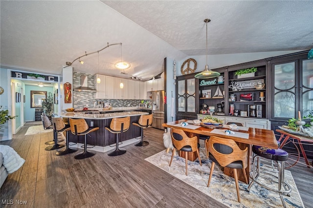 682 2nd St Unit 1, Fairport Harbor, OH 44077 - dining area with a textured ceiling, wood finished floors, and lofted ceiling
