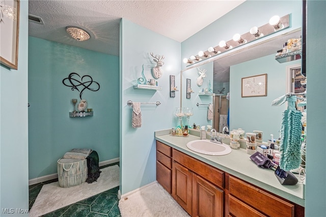 682 2nd St Unit 1, Fairport Harbor, OH 44077 - bathroom featuring vanity, tile patterned floors, a textured ceiling, and a shower