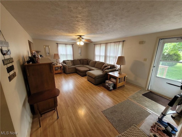 5115 Sangria Dr, West Salem, OH 44287 - living area with light wood-style floors, plenty of natural light, a textured ceiling, ceiling fan, and baseboards