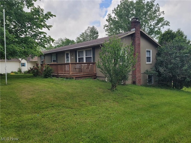 5115 Sangria Dr, West Salem, OH 44287 - view of front of home with a chimney, a wooden deck, and a front yard