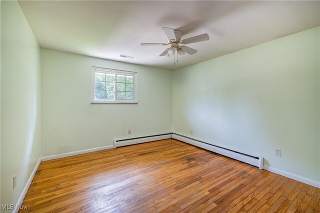 5046 Devon Dr, North Olmsted, OH 44070 - empty room featuring a ceiling fan, wood-type flooring, baseboards, and a baseboard radiator