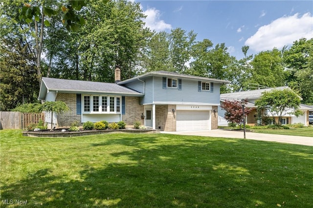 5046 Devon Dr, North Olmsted, OH 44070 - split level home with brick siding, a chimney, driveway, and a garage