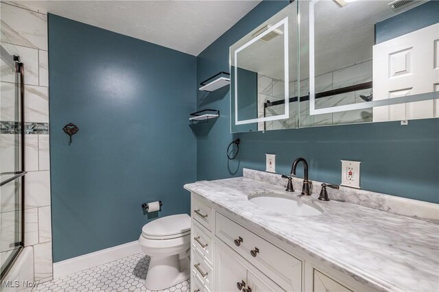 5046 Devon Dr, North Olmsted, OH 44070 - full bath with toilet, vanity, baseboards, tile patterned flooring, and combined bath / shower with glass door