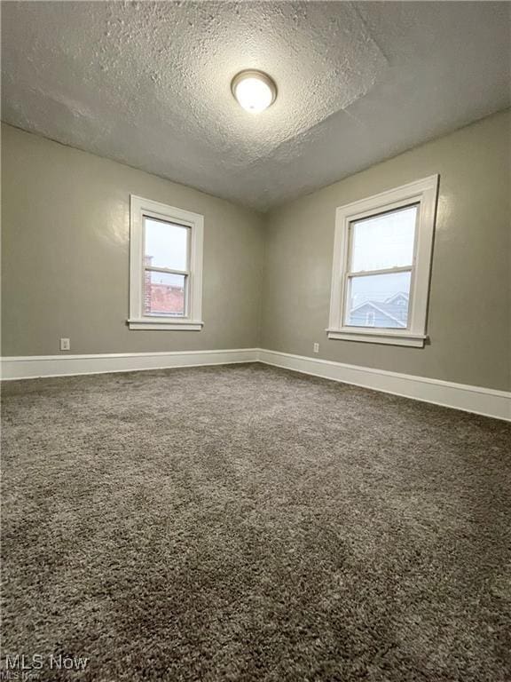 2511 4th St NW, Canton, OH 44708 - carpeted spare room with a textured ceiling and baseboards