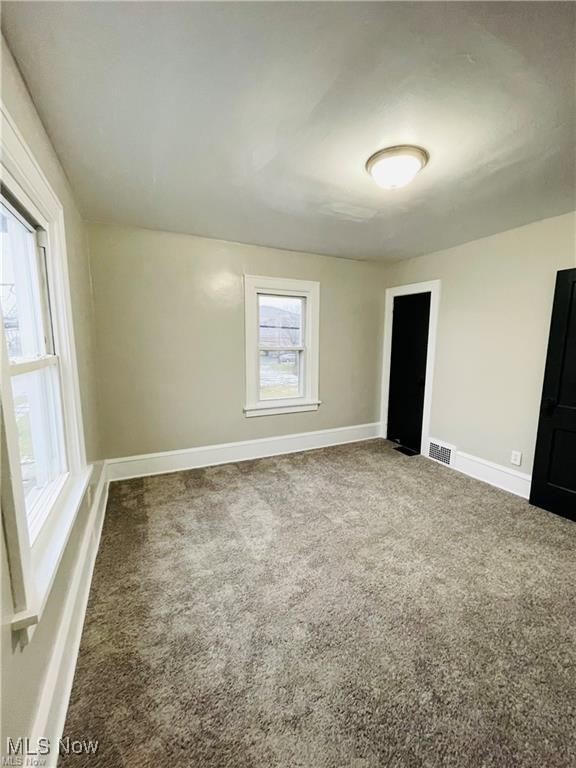 2511 4th St NW, Canton, OH 44708 - unfurnished bedroom with carpet flooring and baseboards
