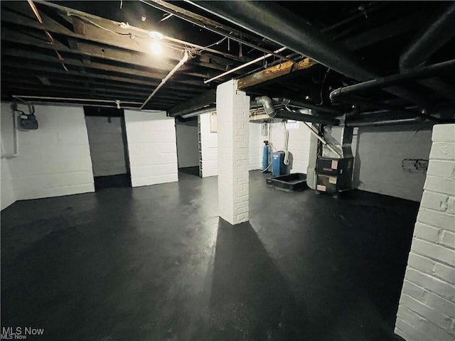 2511 4th St NW, Canton, OH 44708 - unfinished basement featuring heating unit and a water pressure tank