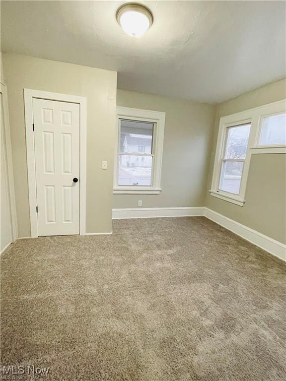 2511 4th St NW, Canton, OH 44708 - unfurnished room featuring baseboards and carpet floors