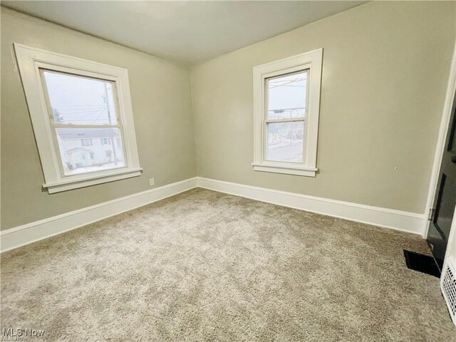 2511 4th St NW, Canton, OH 44708 - spare room with plenty of natural light, carpet flooring, and baseboards