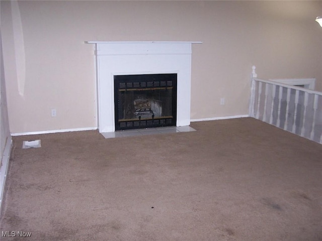 1475 Laurel Dr, West Salem, OH 44287 - unfurnished living room featuring carpet, a fireplace with flush hearth, and baseboards