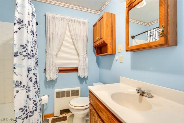 3985 Etter Rd, Mogadore, OH 44260 - full bathroom featuring radiator heating unit, toilet, vanity, and shower / bath combo