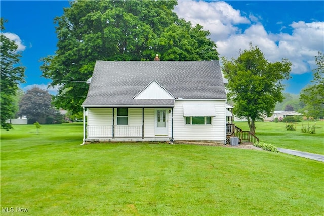 3985 Etter Rd, Mogadore, OH 44260 - view of front facade featuring central air condition unit, a porch, a front yard, and roof with shingles