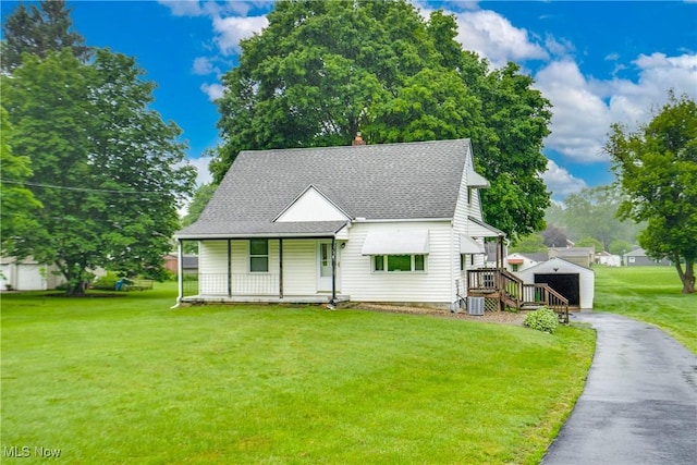 3985 Etter Rd, Mogadore, OH 44260 - view of front of property with covered porch, an outdoor structure, a shingled roof, a front lawn, and a chimney