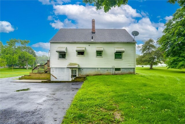 3985 Etter Rd, Mogadore, OH 44260 - back of house featuring a yard, a chimney, and a shingled roof