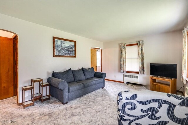 3985 Etter Rd, Mogadore, OH 44260 - living room with arched walkways, radiator, and carpet flooring