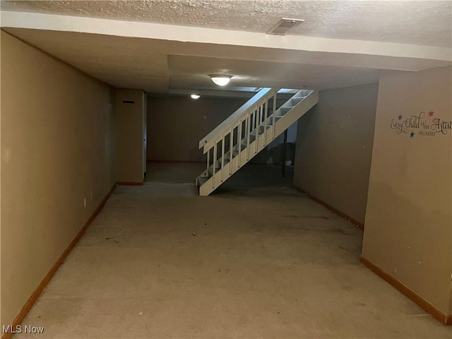 1023 55th St NE, Canton, OH 44721 - finished below grade area with stairs, baseboards, carpet, and a textured ceiling