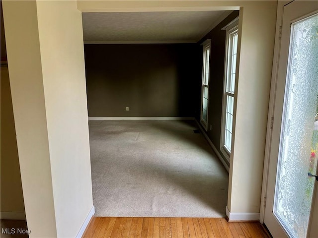 1023 55th St NE, Canton, OH 44721 - unfurnished room featuring plenty of natural light, baseboards, and crown molding